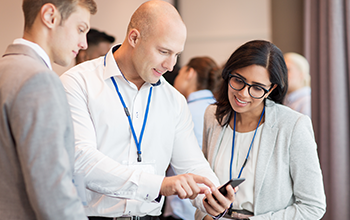 couple with smartphone at business conference